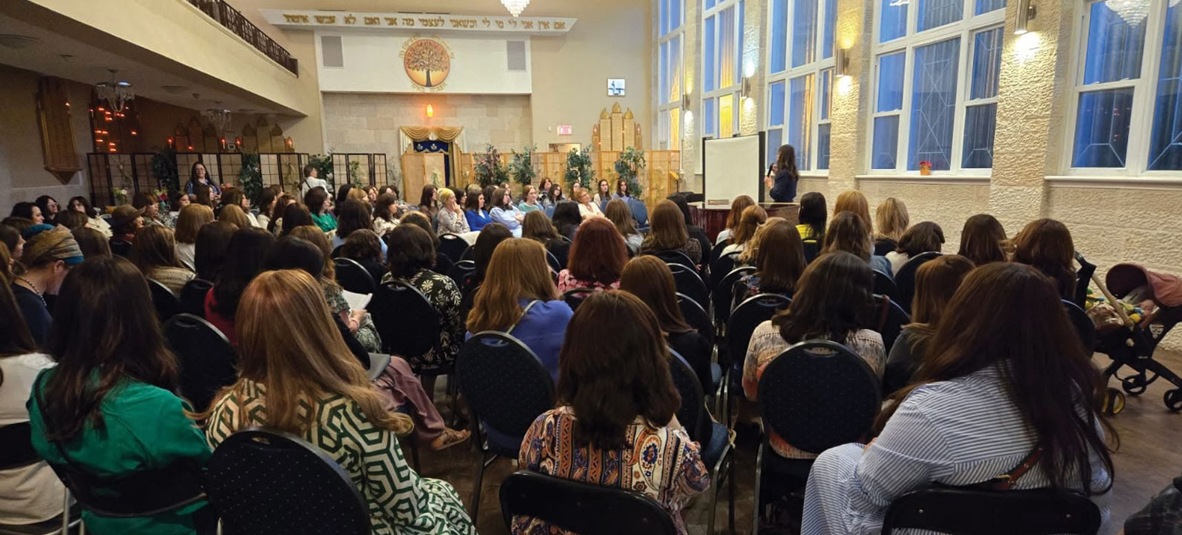Women attending an educational lecture in the main hall