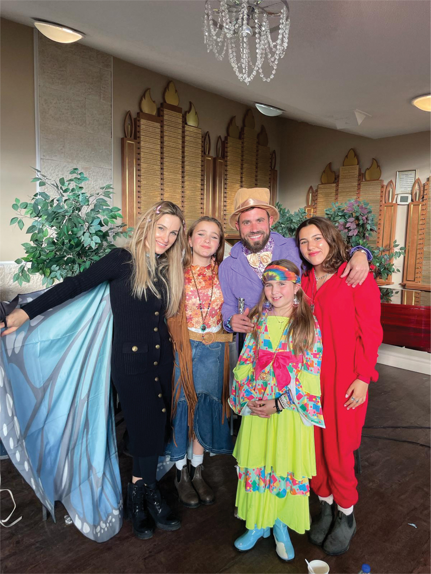 Community members posing in Purim holiday costumes