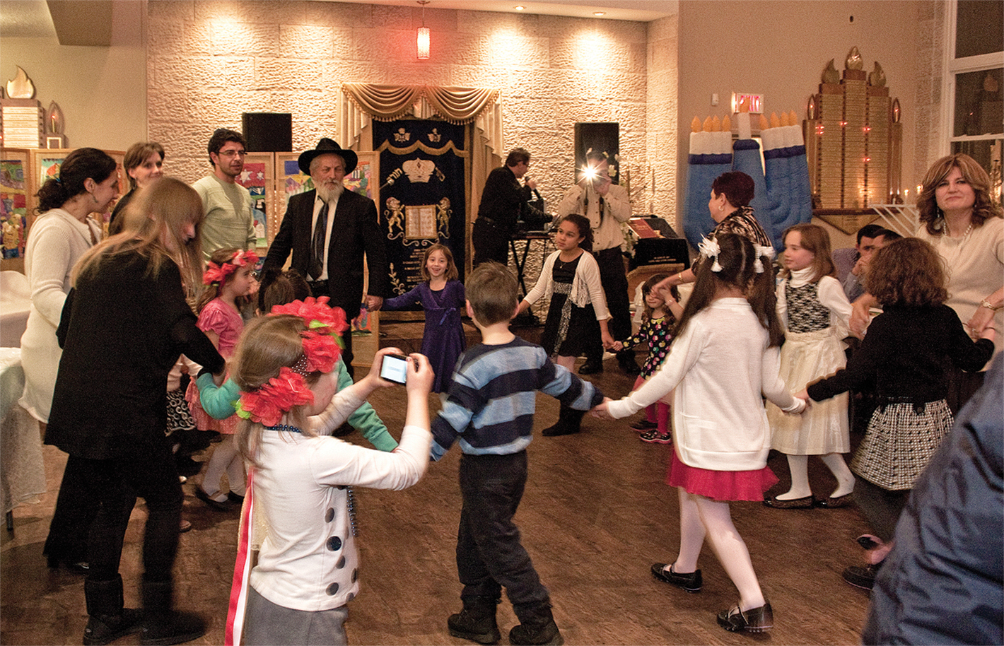 Children dancing in a circle during Chanukah holiday event