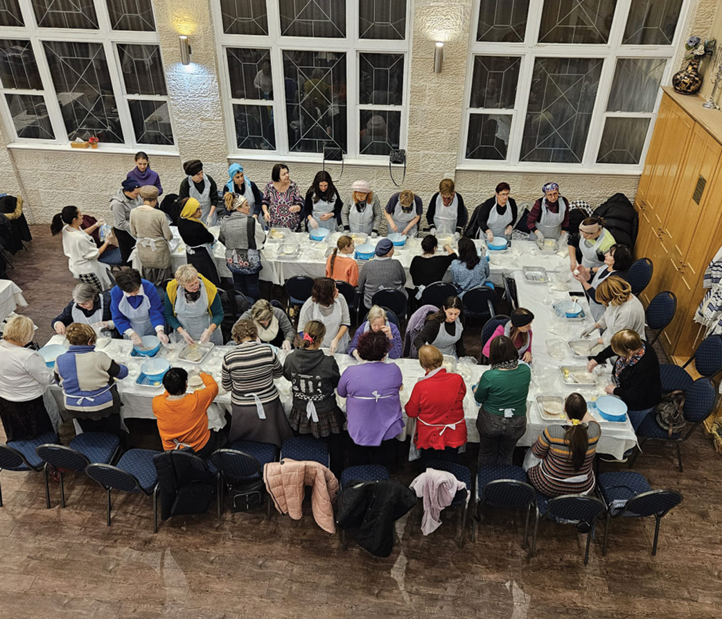 Large community Challah baking workshop with many women participants
