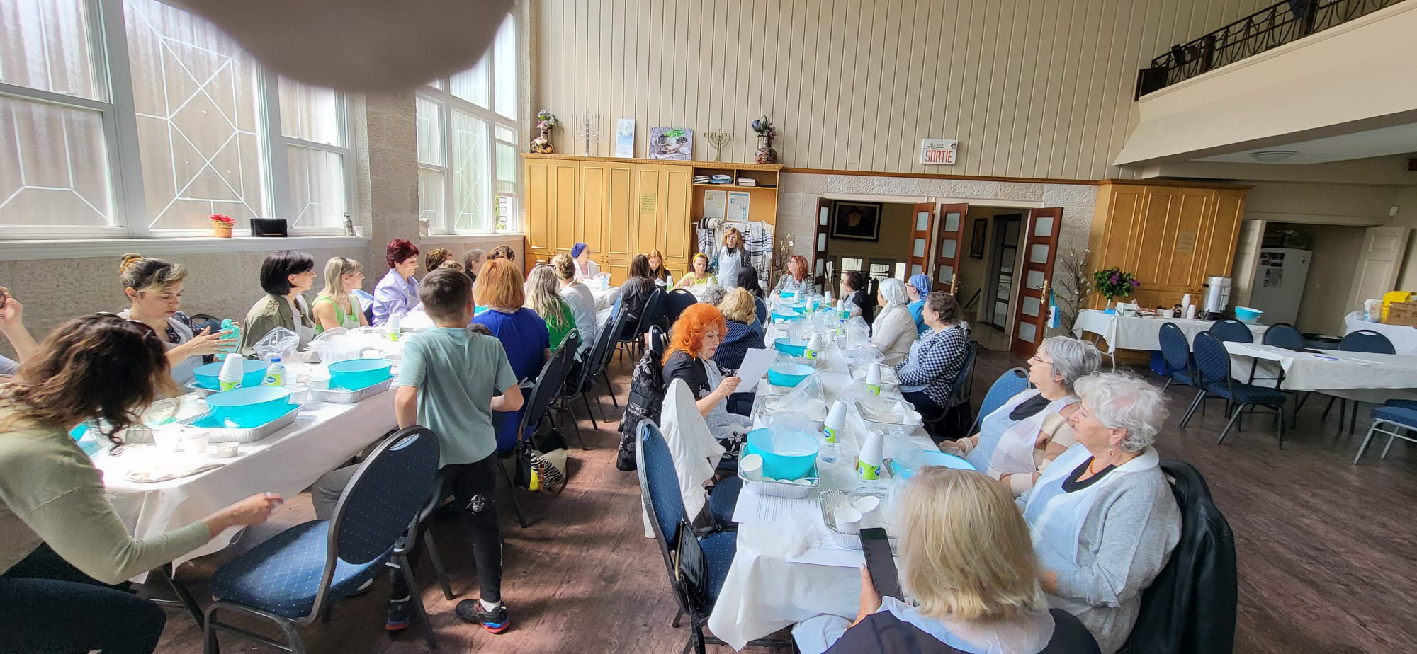 Community members attending a craft class at banquet tables