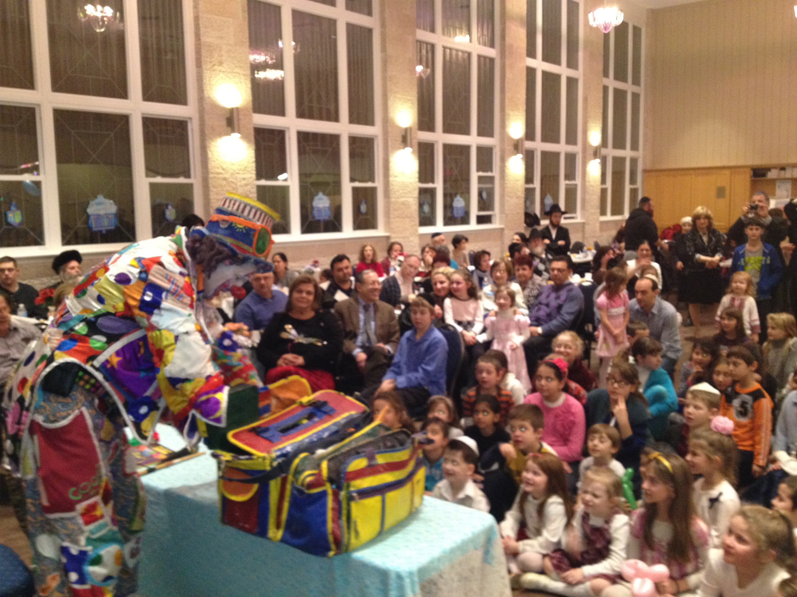 Clown performing a magic show for kids in the community hall